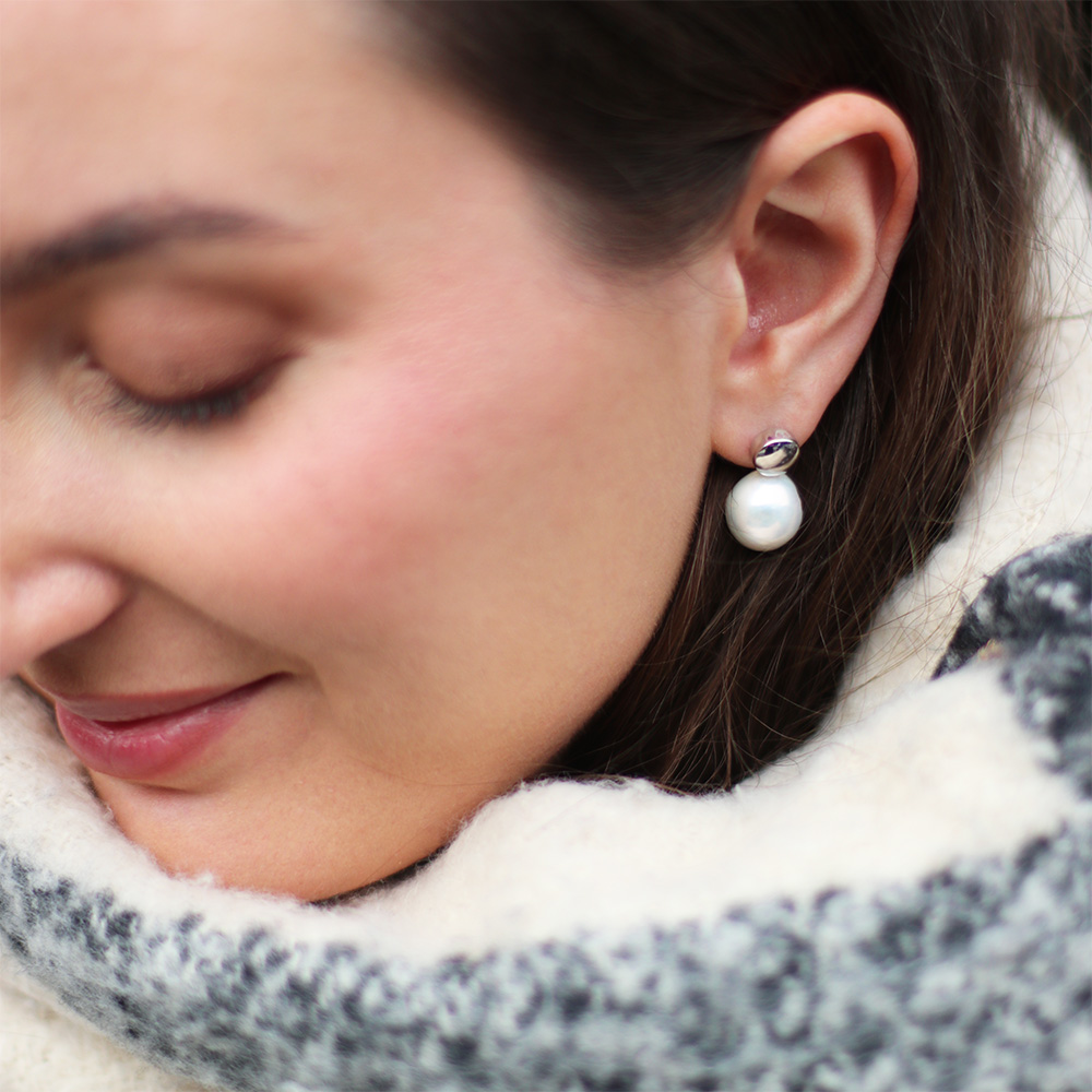 model wearing drop white pearl edison earrings
