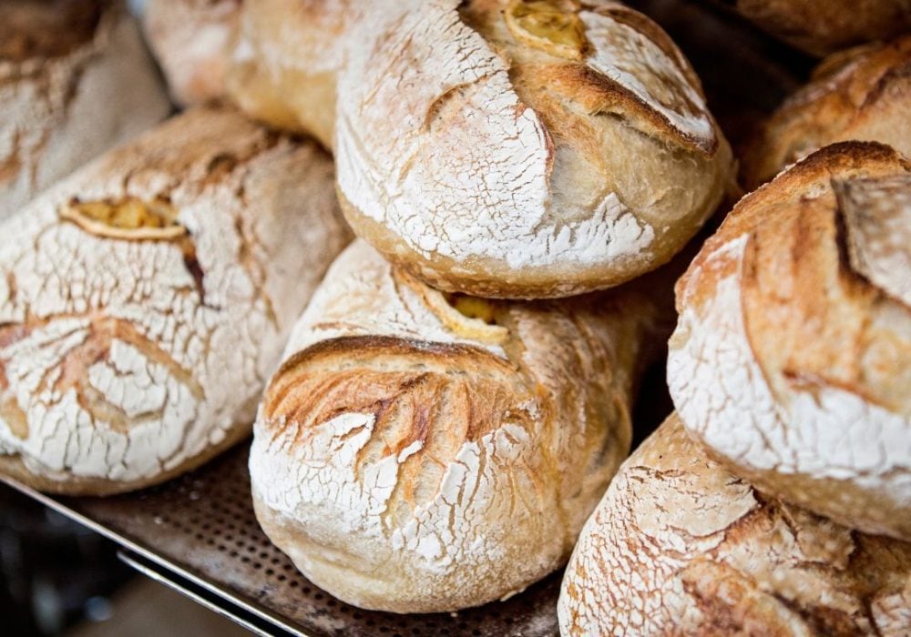 photo of freshly cooked loafs of bread staked up