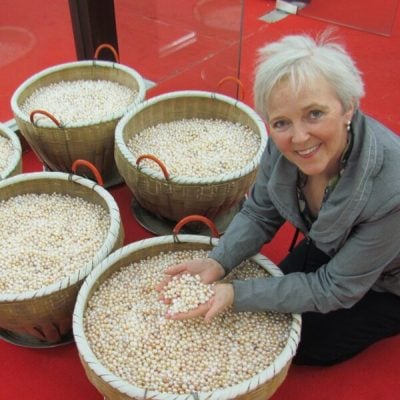 photo of founder Angie Taylor with lots of pears at a pearl farm