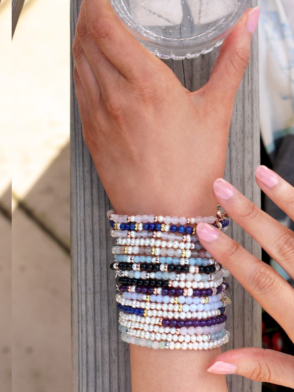 model wearing a stack of sky pearl bracelets