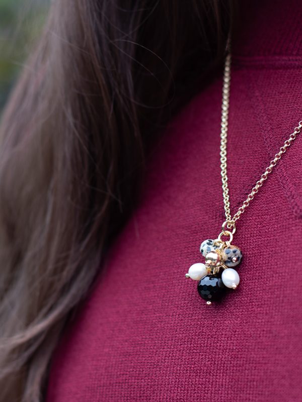 joy pearl necklace on model with red jumper