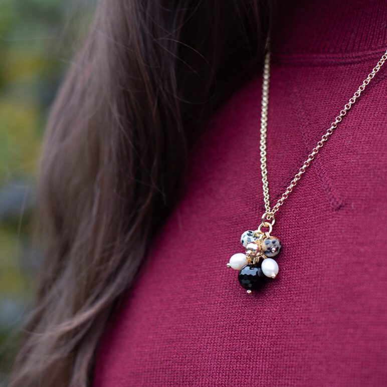 joy pearl necklace on model with red jumper